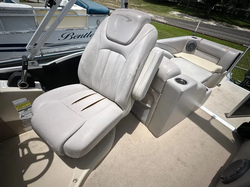 Slide: The Image of 2010 Bennington 2250RCW boat interior with captain's chair and seating area. - 15