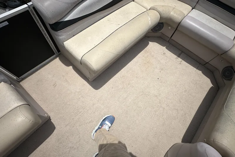 Slide: The Image of 2010 Bennington 2250RCW boat interior with beige seating and carpet. - 20