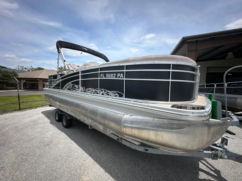 Slide: The Image of 2010 Bennington 2250RCW pontoon boat on a trailer, parked outdoors. - 4