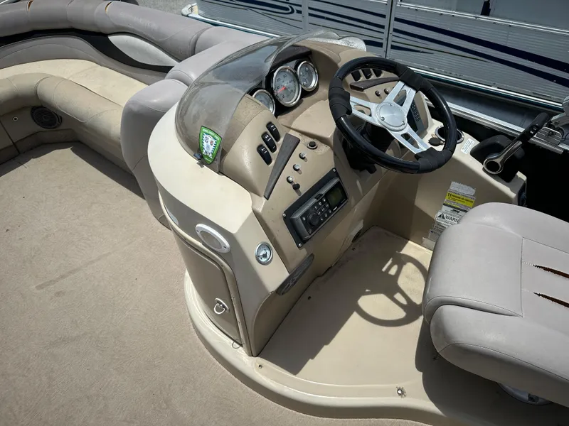 Slide: The Image of 2010 Bennington 2250RCW boat interior with steering console and seating. - 7