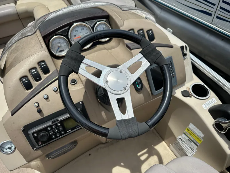 Slide: The Image of Steering console of a 2010 Bennington 2250RCW boat with gauges and controls. - 8
