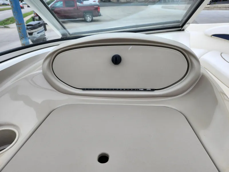 Slide: The Image of Dashboard of a 2002 Bayliner 215 Capri boat with storage compartment. - 17