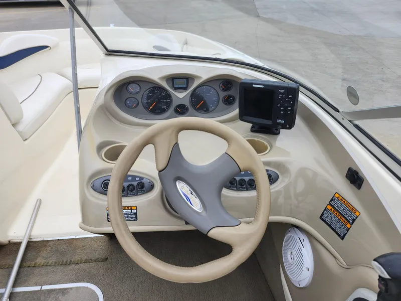 Slide: The Image of 2002 Bayliner 215 Capri boat dashboard with steering wheel and instrument panel. - 21