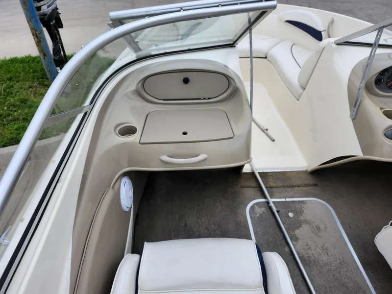 Slide: The Image of 2002 Bayliner 215 Capri boat interior with seating and storage compartments. - 23