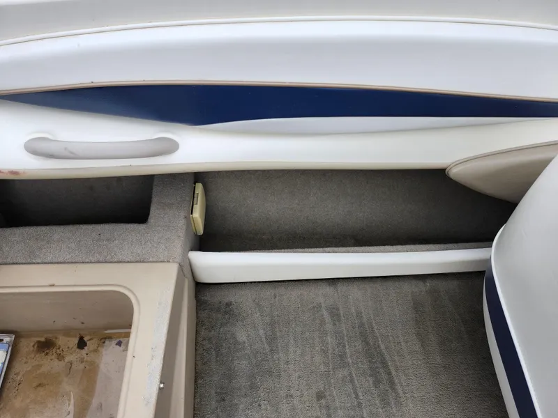 Slide: The Image of Interior of a 2002 Bayliner 215 Capri boat showing seating and storage areas. - 24