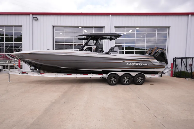 The Image of 2024 Sunsation 32 CCX boat on a trailer outside a building. - 0
