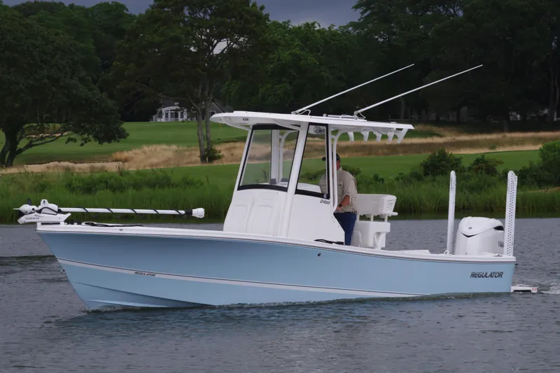 Slide: The Image of 2025 Regulator 24XO boat cruising on a calm lake. - 10