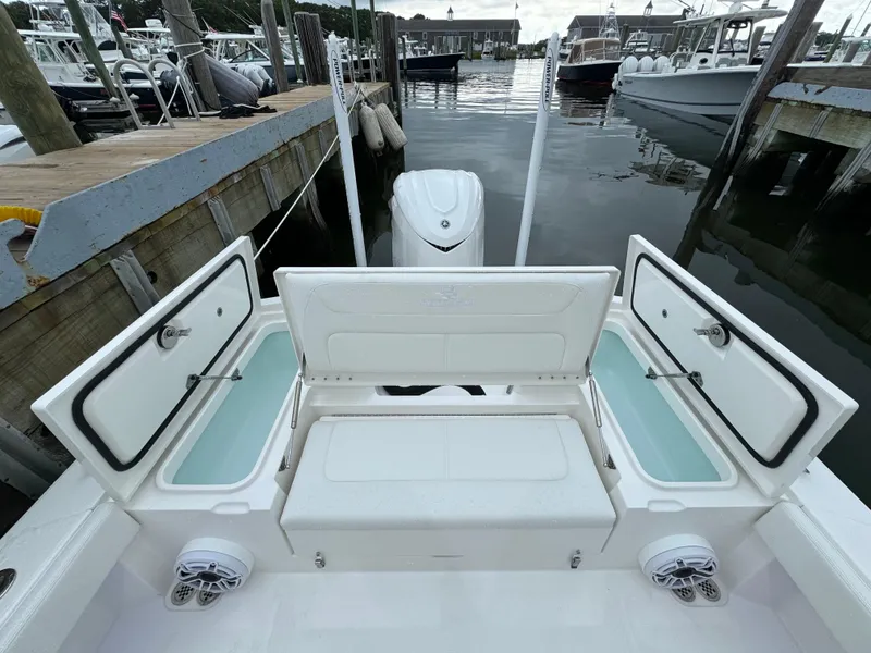 Slide: The Image of 2025 Regulator 24XO boat at dock with open storage compartments. - 14
