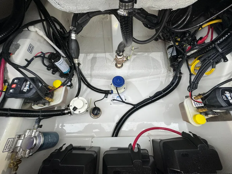Slide: The Image of 2025 Regulator 24XO boat engine compartment with wiring and components. - 16