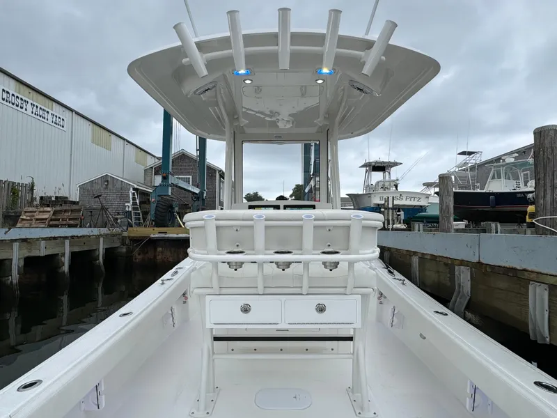 Slide: The Image of 2025 Regulator 24XO boat docked at a marina, showcasing its spacious deck and modern design. - 17