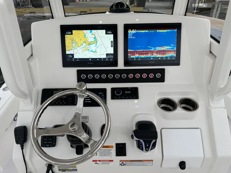 Slide: The Image of 2025 Regulator 24XO boat dashboard with navigation and fish finder screens. - 20
