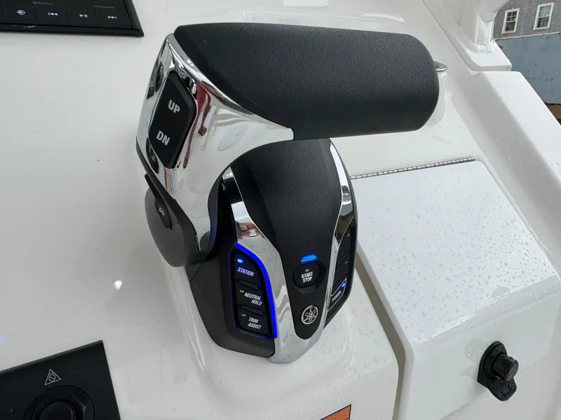 Slide: The Image of 2025 Regulator 24XO boat throttle control with buttons and chrome finish. - 23