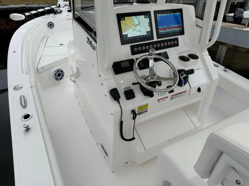 Slide: The Image of 2025 Regulator 24XO boat cockpit with advanced navigation system and steering wheel. - 25