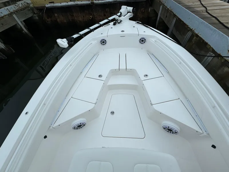 Slide: The Image of 2025 Regulator 24XO boat deck with storage compartments and speakers. - 26