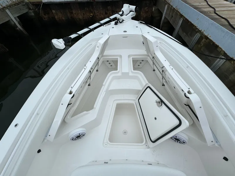 Slide: The Image of 2025 Regulator 24XO boat bow with storage compartments open. - 27