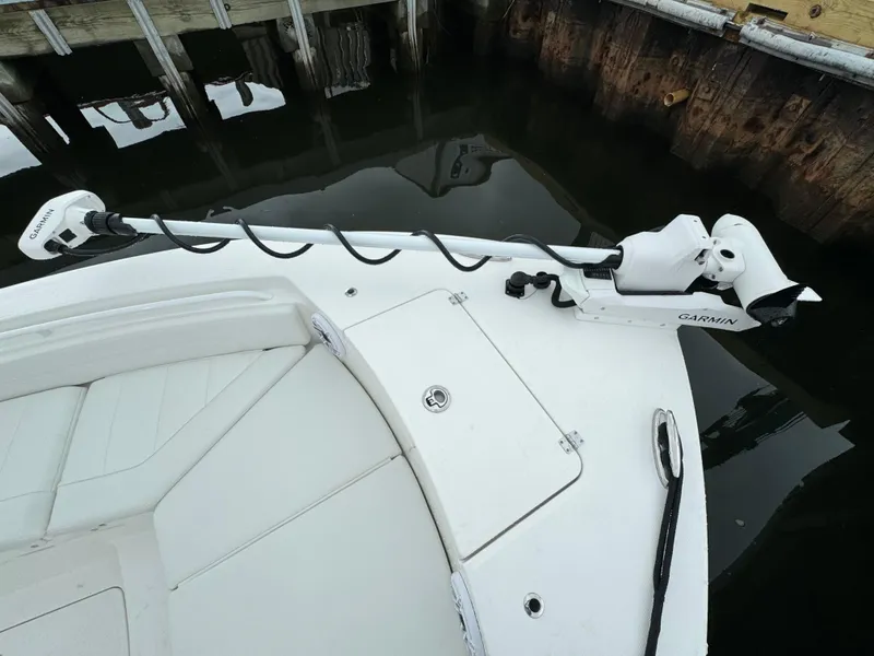 Slide: The Image of Regulator 24XO 2025 boat with Garmin trolling motor docked. - 30
