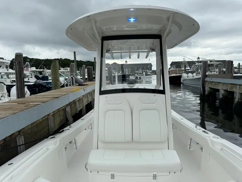 Slide: The Image of 2025 Regulator 24XO boat docked at a marina on a cloudy day. - 31