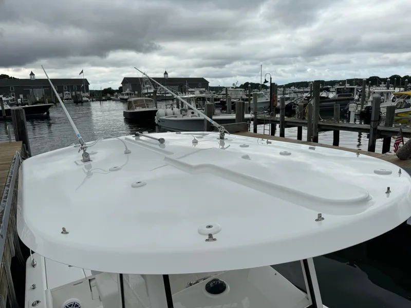 Slide: The Image of 2025 Regulator 24XO boat docked at a marina under cloudy skies. - 32