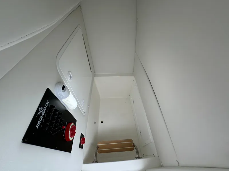 Slide: The Image of Interior cabin of 2025 Regulator 24XO boat with control panel and storage. - 33