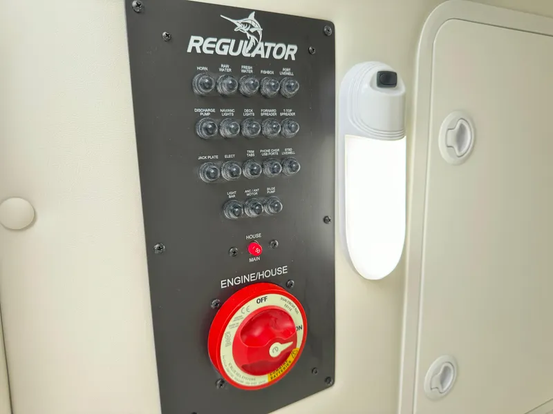 Slide: The Image of Control panel of 2025 Regulator 24XO boat with switches and engine/house selector. - 34