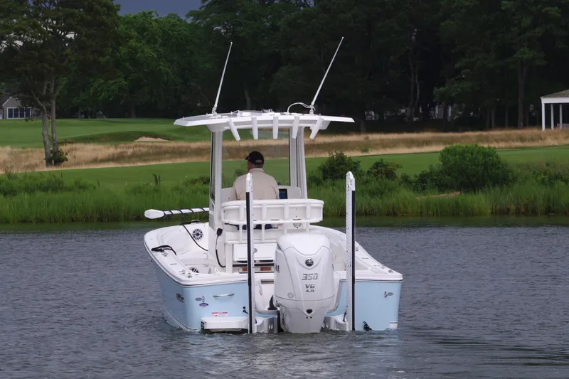 Slide: The Image of 2025 Regulator 24XO boat cruising on a calm lake. - 8