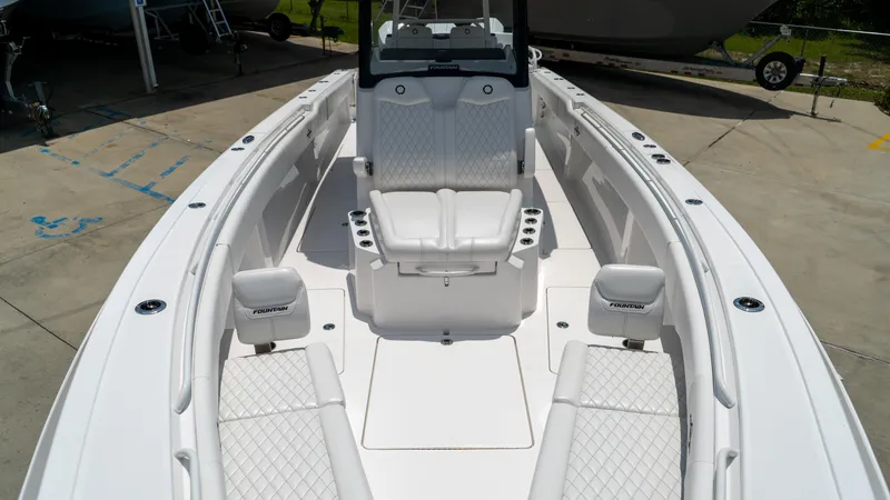 Slide: The Image of 2025 Fountain 38 TE boat interior with white seating and spacious deck. - 10