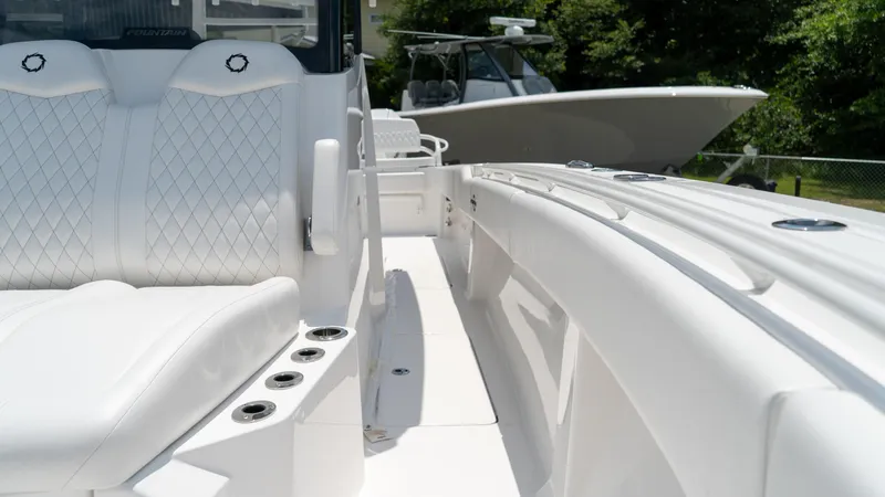 Slide: The Image of 2025 Fountain 38 TE boat interior with white leather seats and cup holders. - 14