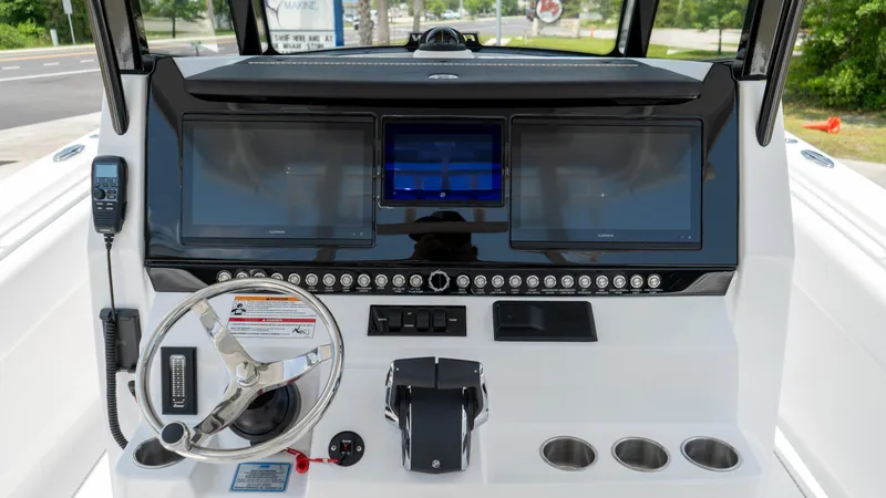 Slide: The Image of Control console of 2025 Fountain 38 TE boat with dual screens and steering wheel. - 18