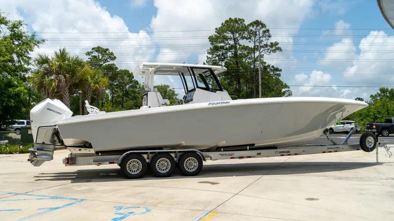 Slide: The Image of 2025 Fountain 38 TE boat on a trailer in a sunny outdoor setting. - 2
