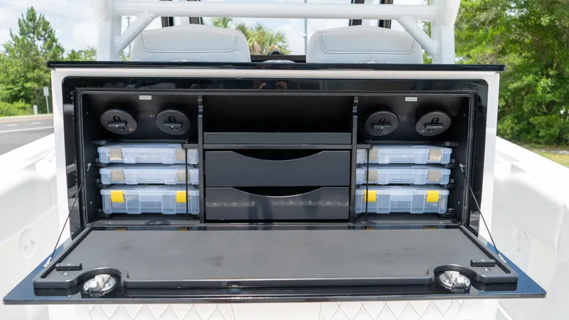 Slide: The Image of Fountain 38 TE 2025 model with open storage compartment showcasing organized tackle boxes. - 26