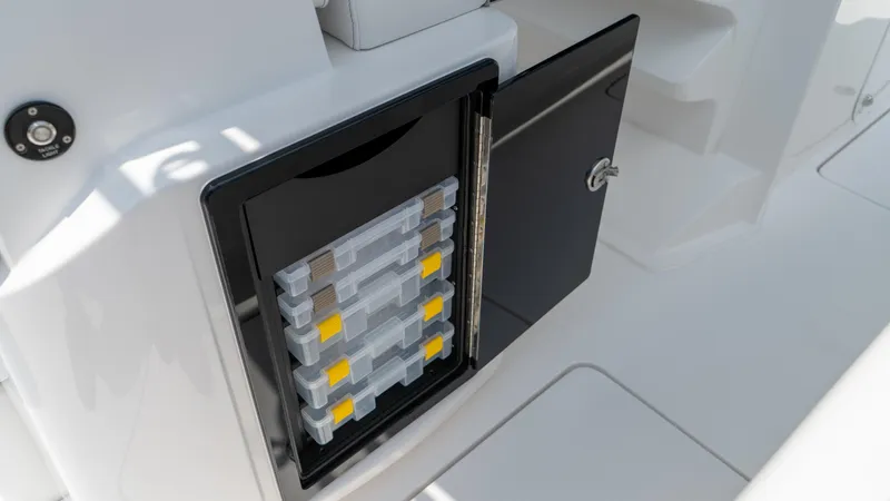 Slide: The Image of Open storage compartment on a 2025 Fountain 38 TE boat with organized tackle boxes. - 27