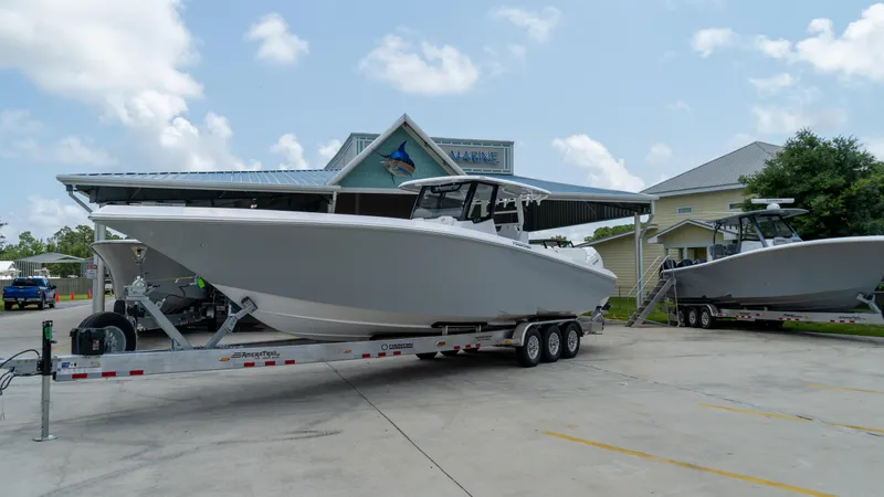 Slide: The Image of 2025 Fountain 38 TE boat on a trailer outside a marine dealership. - 5