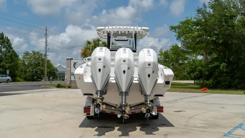 Slide: The Image of 2025 Fountain 38 TE boat with triple outboard engines, rear view. - 7