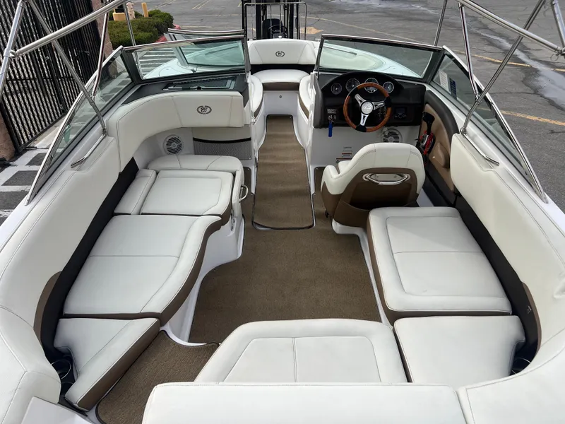 Slide: The Image of 2017 Cobalt 220S boat interior with white and brown seating. - 11