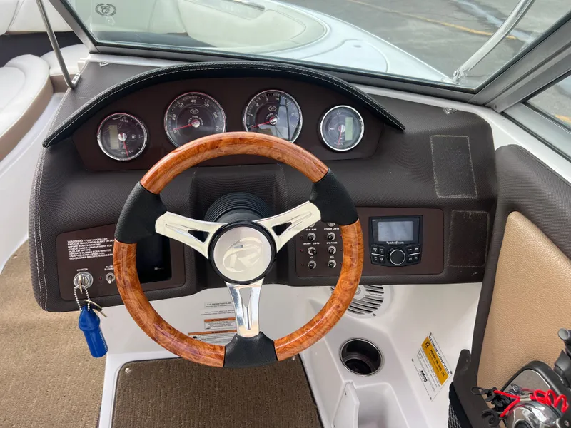 Slide: The Image of 2017 Cobalt 220S boat dashboard with wooden steering wheel and instrument panel. - 12