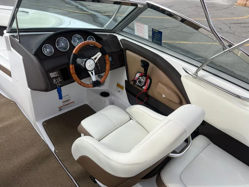 Slide: The Image of 2017 Cobalt 220S boat interior with steering wheel and captain's chair. - 13