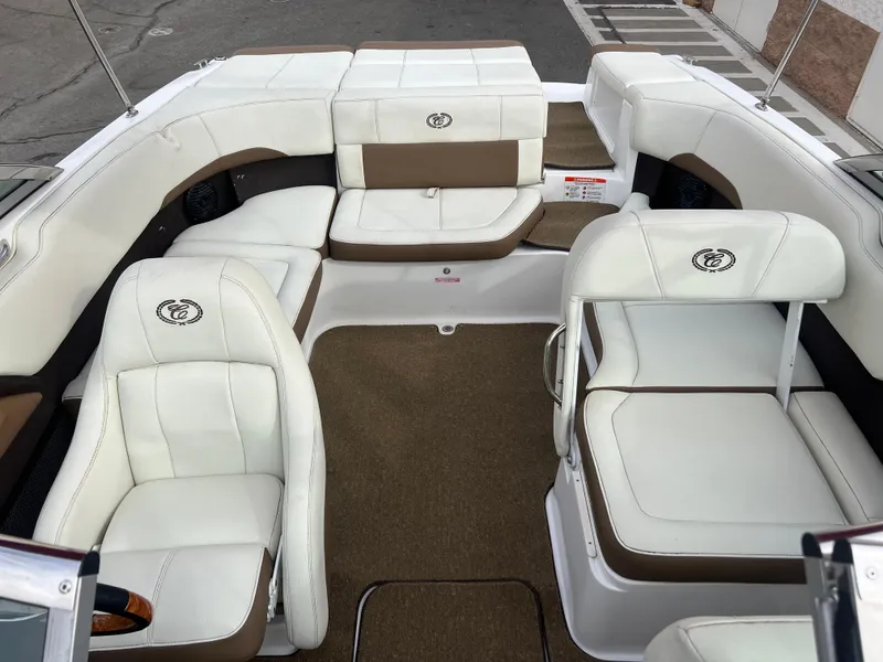 Slide: The Image of 2017 Cobalt 220S boat interior with white and brown seating. - 17