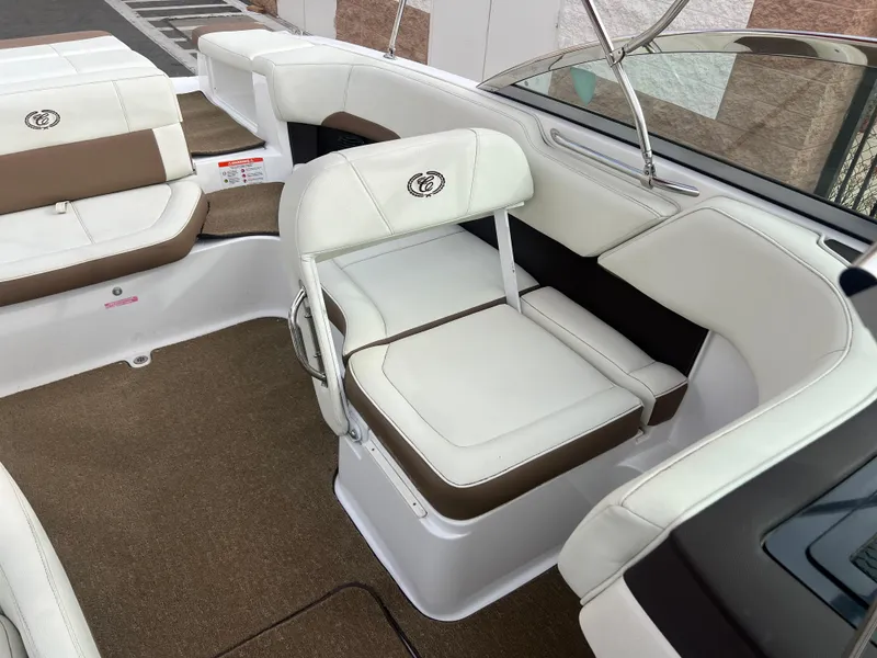 Slide: The Image of 2017 Cobalt 220S boat interior with white and brown seating. - 18