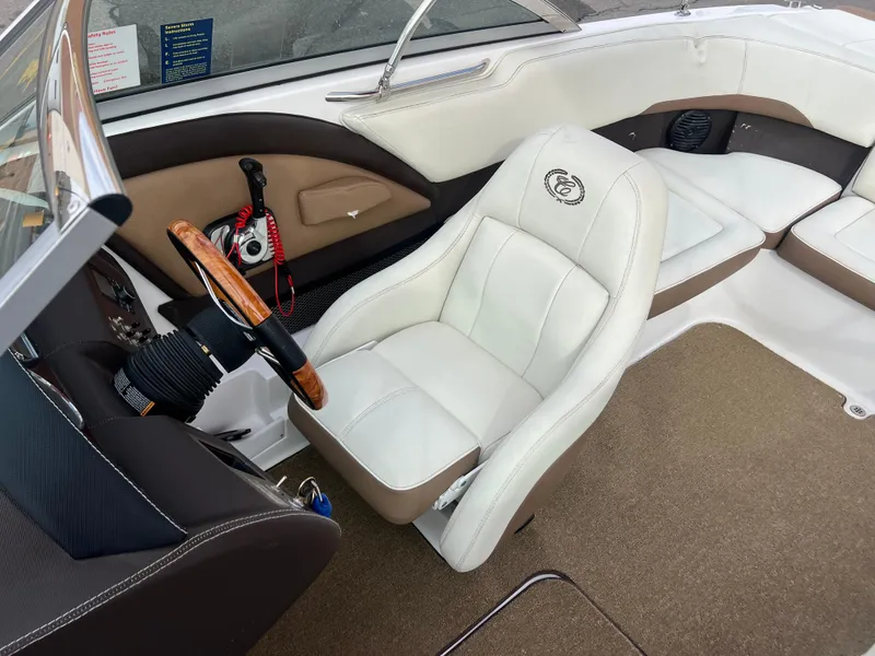 Slide: The Image of 2017 Cobalt 220S boat interior with white leather seats and wooden steering wheel. - 20