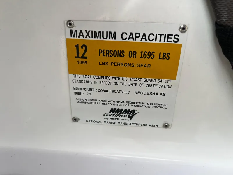Slide: The Image of 2017 Cobalt 220S boat capacity label: 12 persons or 1695 lbs. - 23