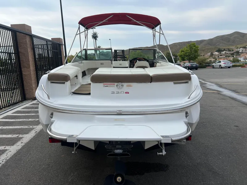 Slide: The Image of 2017 Cobalt 220S boat with red canopy, parked in a lot, rear view. - 4