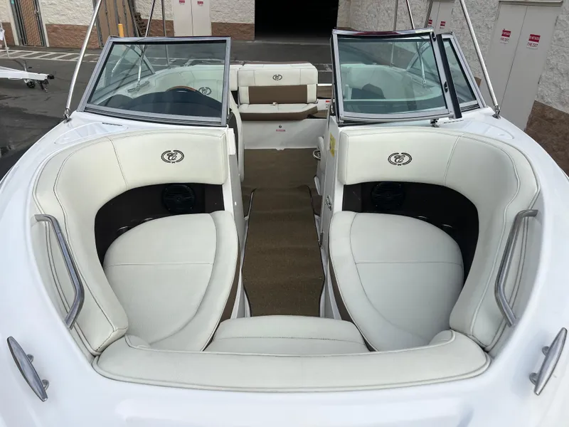 Slide: The Image of 2017 Cobalt 220S boat interior with white leather seating and open bow design. - 6