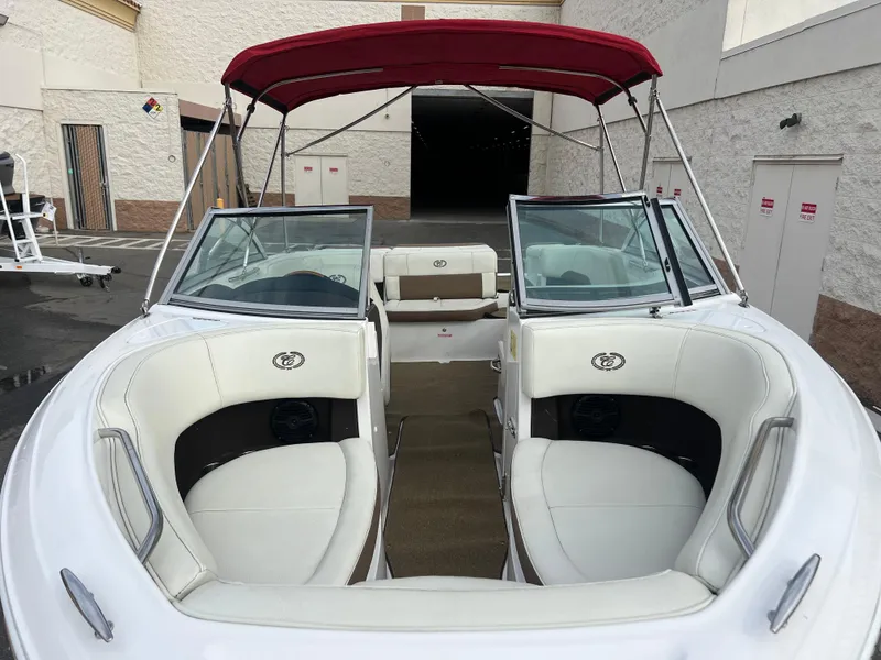 Slide: The Image of 2017 Cobalt 220S boat with red canopy and white interior seating. - 7