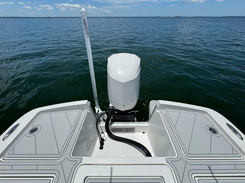 Slide: The Image of 2020 Regulator 26XO boat stern with outboard motor on open water. - 12