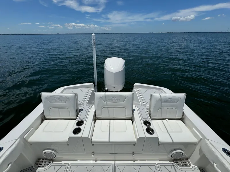 Slide: The Image of 2020 Regulator 26XO boat with seating and outboard motor on open water. - 13
