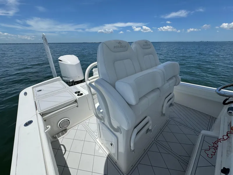 Slide: The Image of 2020 Regulator 26XO boat interior with white seating and ocean view. - 16