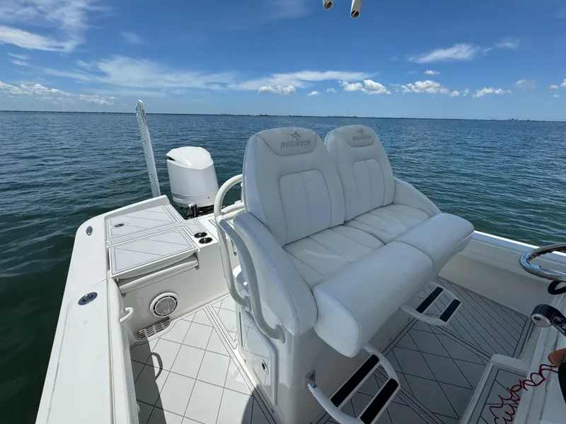 Slide: The Image of 2020 Regulator 26XO boat with white seating on open water. - 17