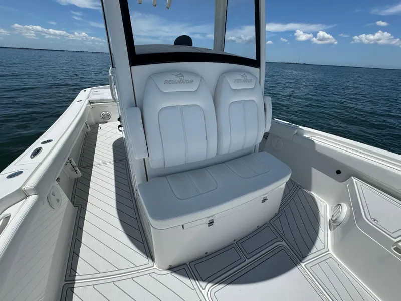 Slide: The Image of 2020 Regulator 26XO boat interior with white seating and ocean view. - 18