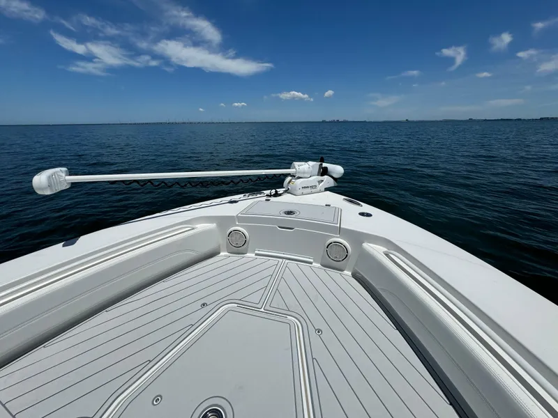 Slide: The Image of 2020 Regulator 26XO boat bow on open water under clear sky. - 19