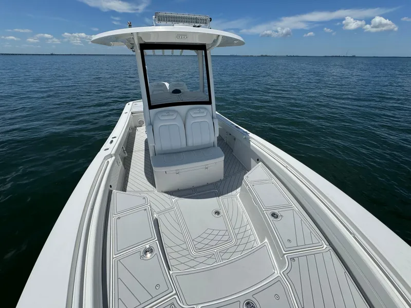 Slide: The Image of 2020 Regulator 26XO boat on open water, showcasing spacious deck and seating. - 20